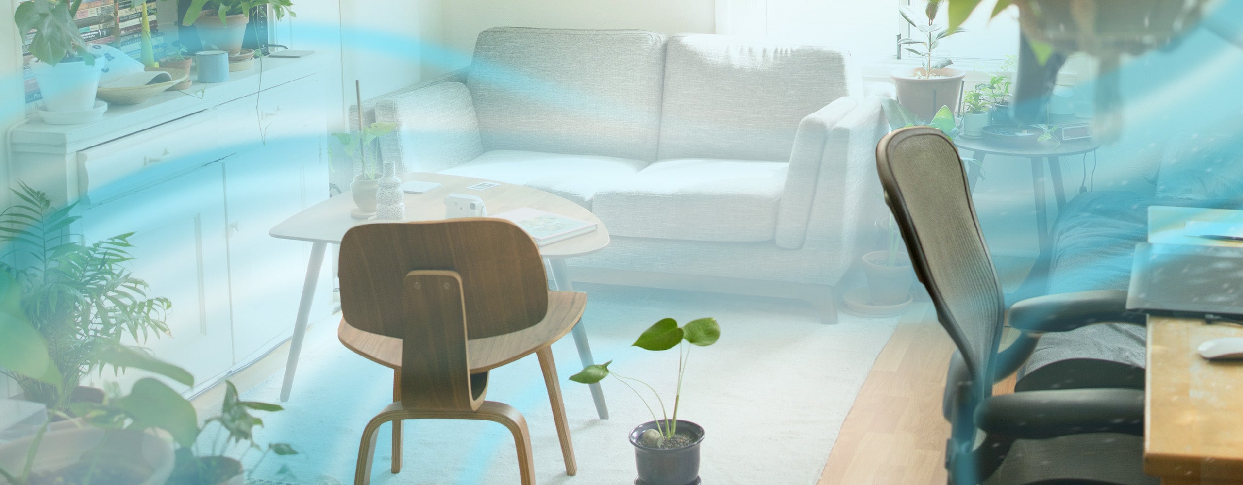 Modern living room with a sofa, coffee table, and chairs, featuring air purifier waves