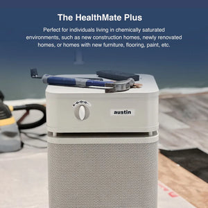Austin HealthMate Plus air purifier on a construction site with tools and protective sheeting.