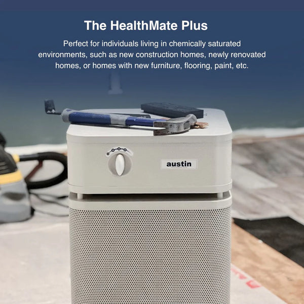 Austin HealthMate Plus air purifier on a construction site with tools and protective sheeting.