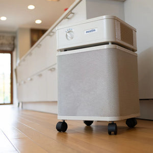 Air purifier with 'austin' branding on a wooden floor in a kitchen