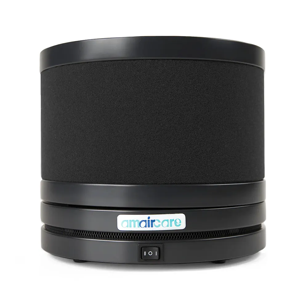 Small round air purifier with black design on a white background