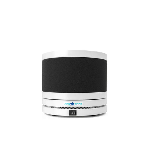 Small round air purifier with white design on a white background